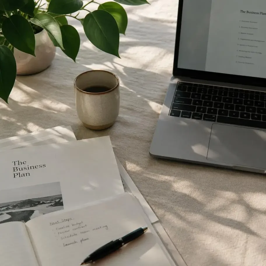 Documents and a laptop on linen in soft light
