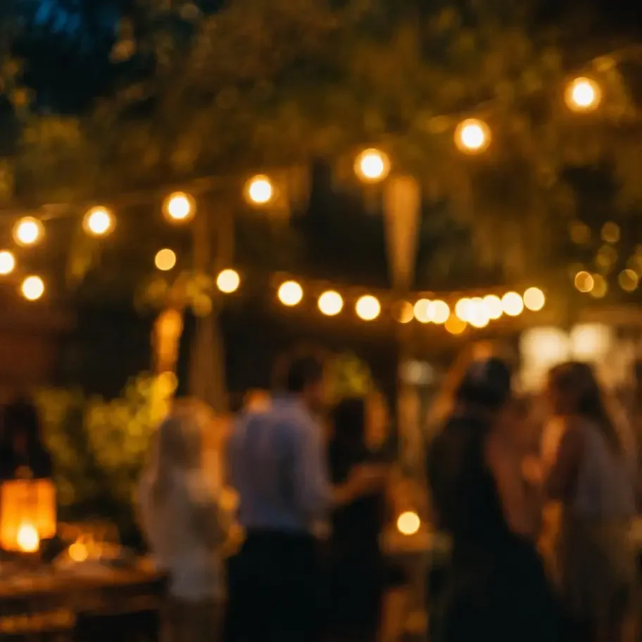An evening garden event with string lights and people out of focus